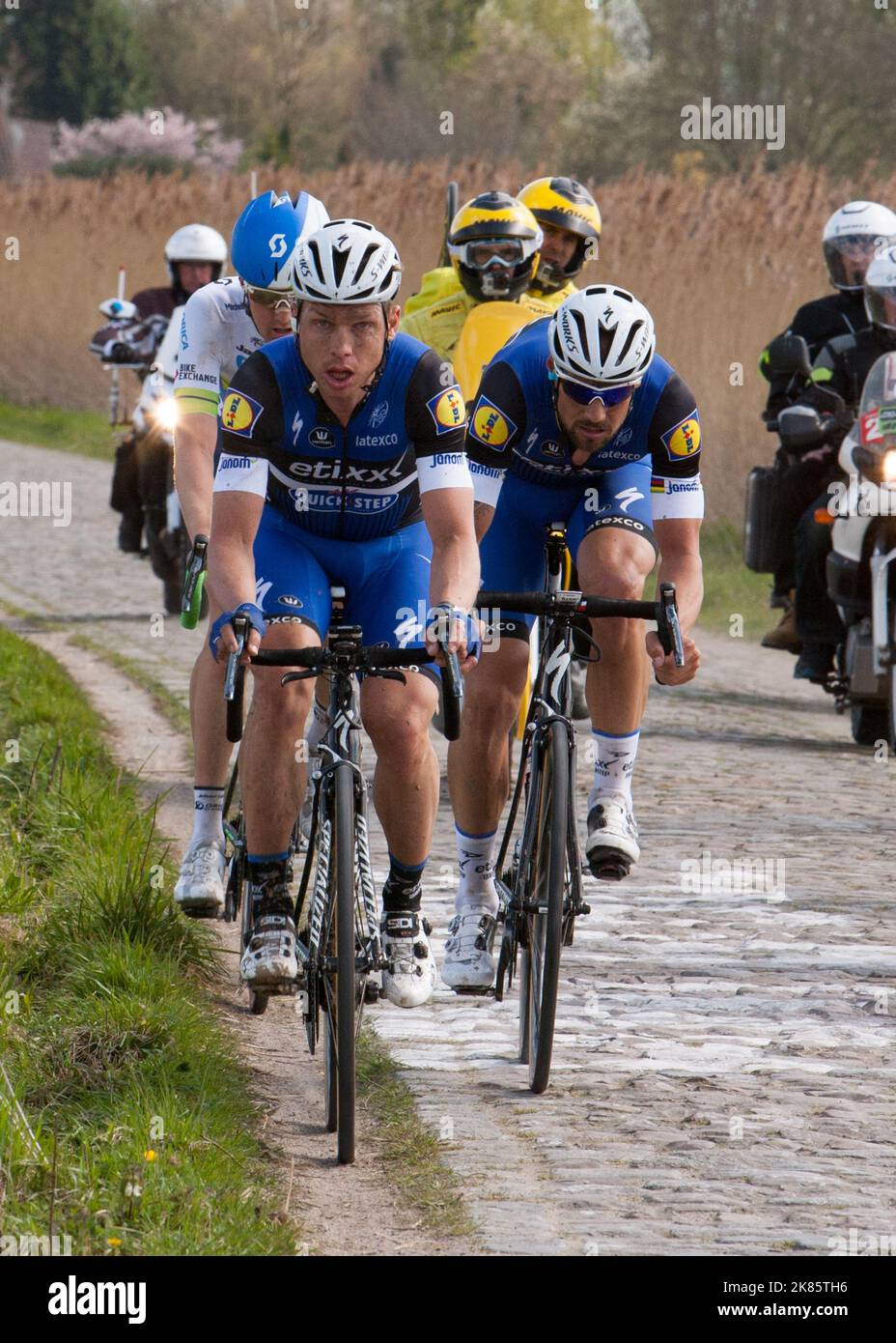 Tony Martin drives the pace for team mate Tom Boonen (Ettix Quick Step) at they head into cobbled sector 17 Stock Photo