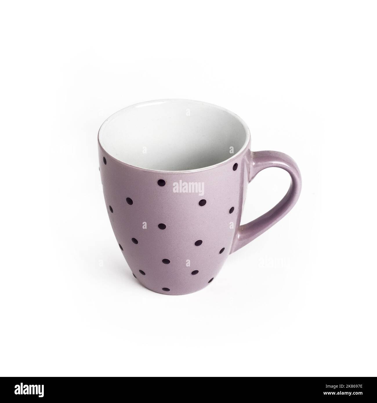 Purple dotted tea cup isolated on white background with clipping path. Copy space Stock Photo