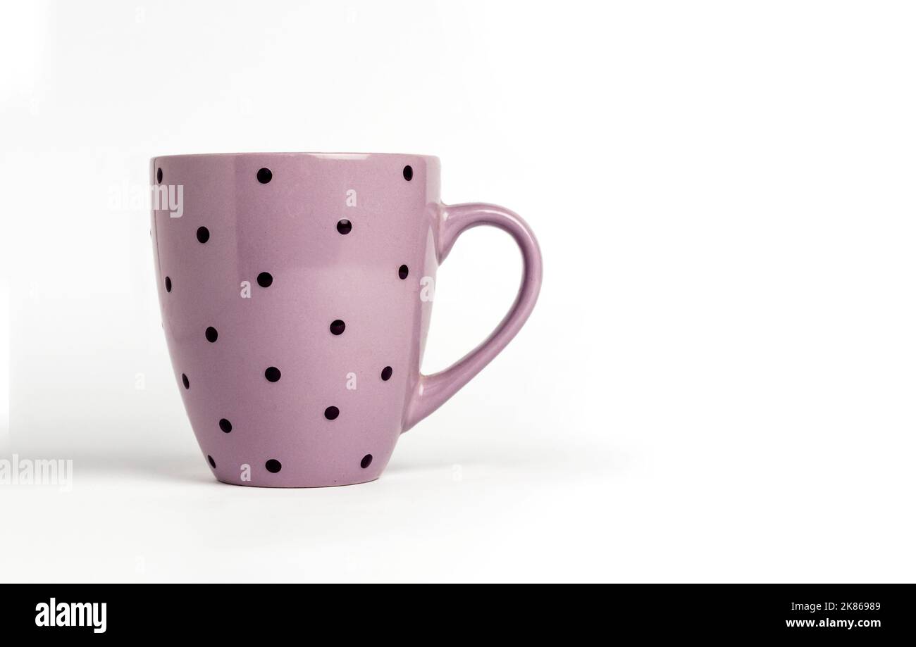 Purple dotted tea cup isolated on white background. Copy space Stock Photo