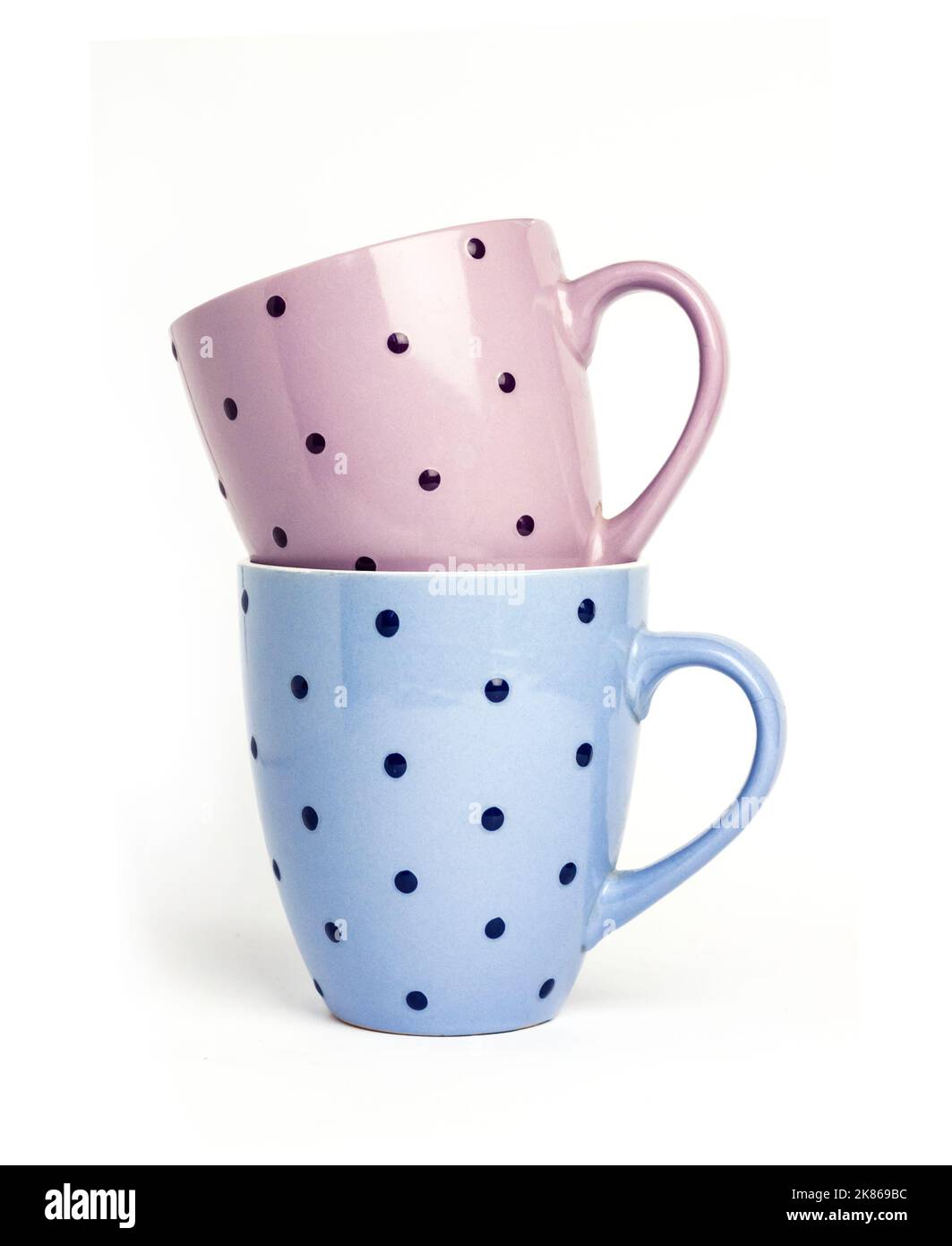 Two colorful dotted mugs isolated on white background Stock Photo