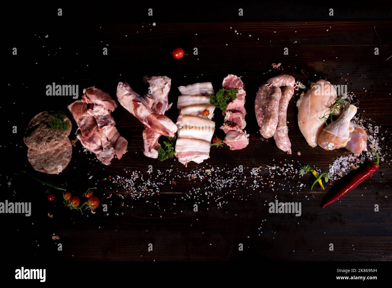Various types of raw meat of beef, pork, chicken on a stone background