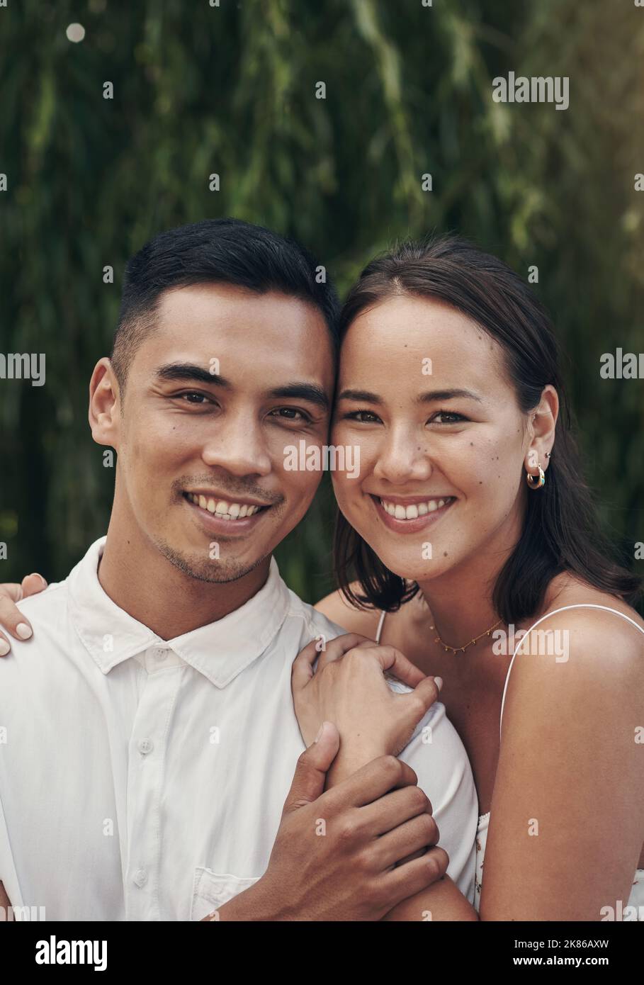 Were stronger when were together. a happy young couple standing close together outside during the day. Stock Photo