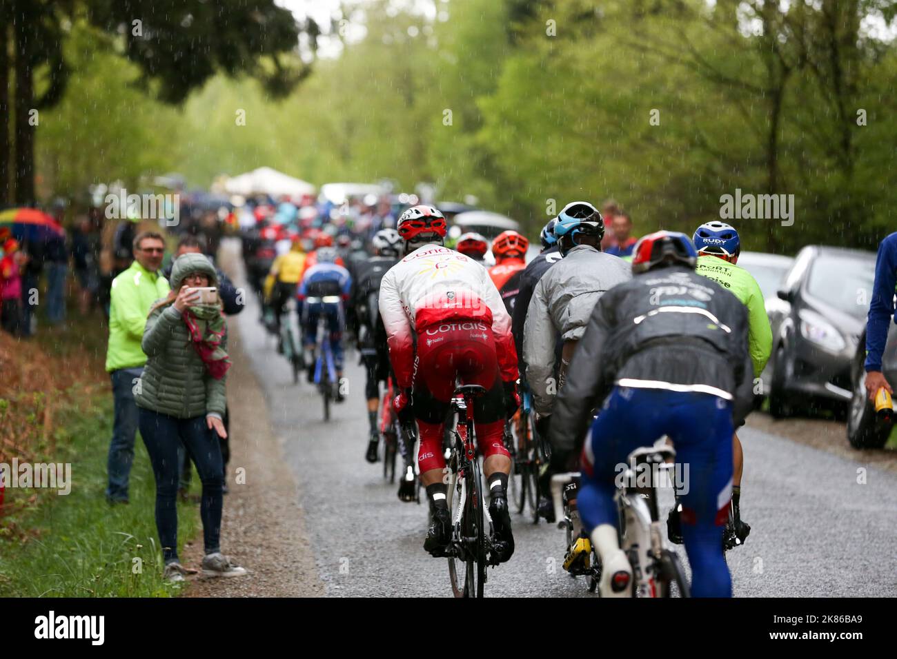 The climbs do their damage during the race as the back of the peloton stretches out Stock Photo