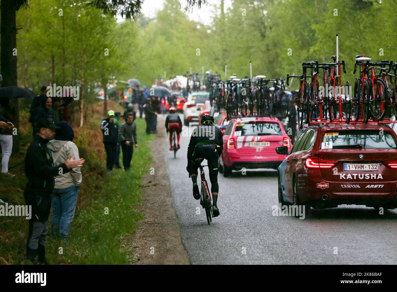 The climbs do their damage during the race as the back of the peloton stretches out Stock Photo