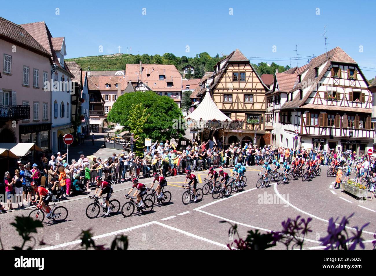 The chasing peloton including Team  Ineos's Geraint Thomas, Egan Bernal, Luke Rowe, Jonathan Castroviejo, Dylan Van Baarle, and Michal Kwiatowski, Gianni Moscon ride through the pretty town of  Rosheim during the Tour de France 2019 Stage 5 - Saint-Die-Des-Vosges to Colmar Stock Photo
