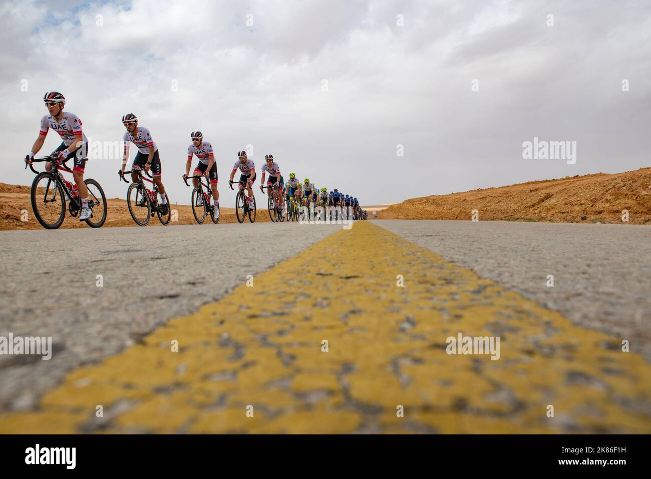 The chasing Peloton riding though the Saudi desert during Stage Two of ...