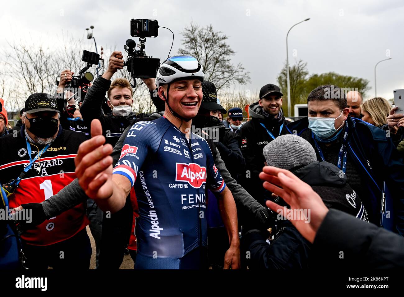 The 2022 Tour of Flanders from Antwerp (Antwerpen) to Oudenaarde. Mathieu Van Der Poel for team AlpecinFenix (NED) embraces his team mate on the finish line after winning the stage. Stock Photo