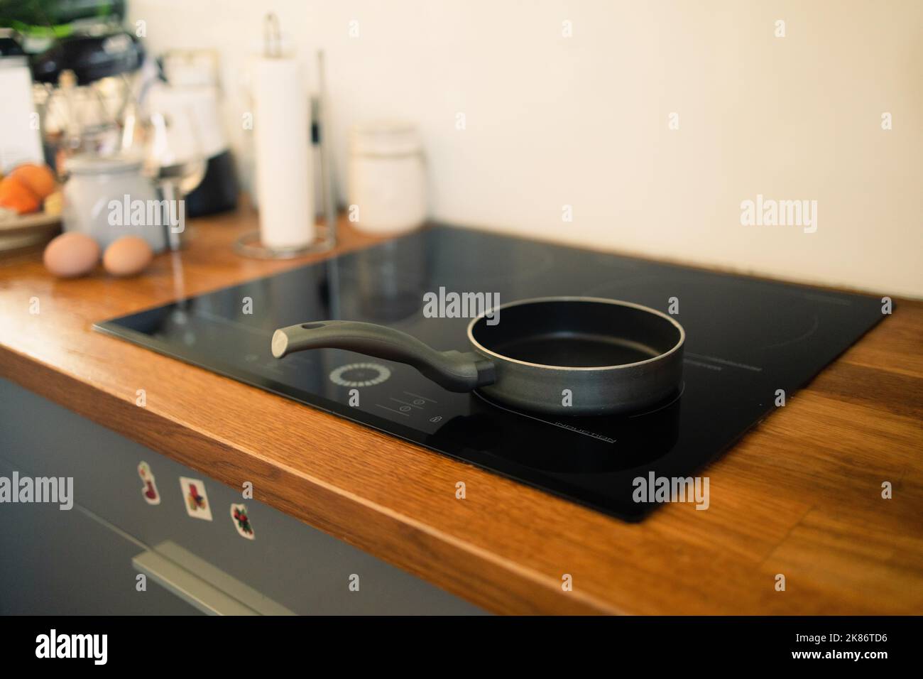 Frying pan on modern black induction stove, cooker, hob or built in