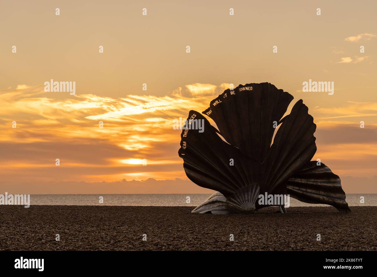 Autumn sunrise at the Scallop sculpture on Aldeburgh beach. Suffolk. UK Stock Photo