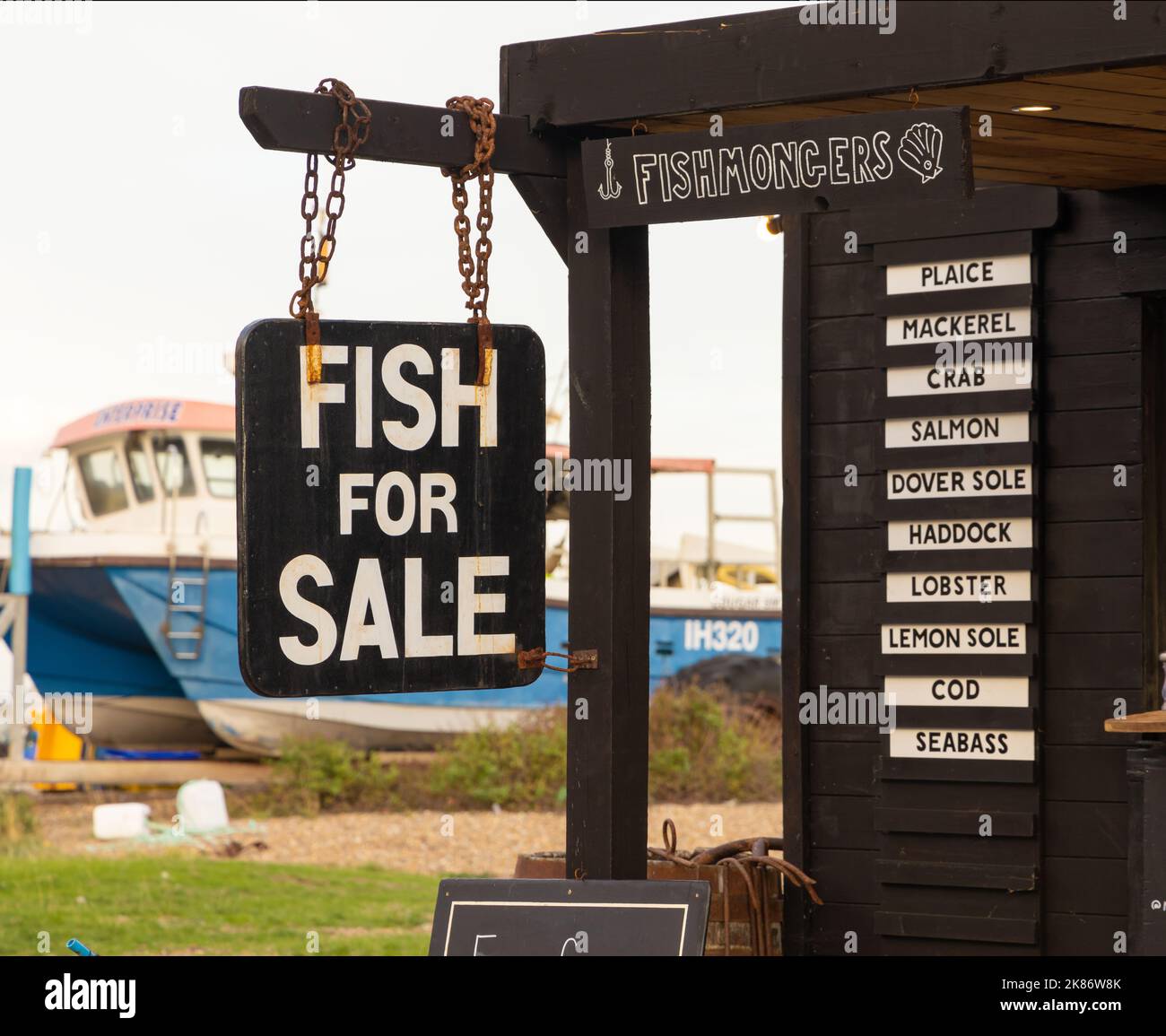Fish For Sale sign at a fishmonger on Aldeburgh Beach. Suffolk. UK Stock Photo