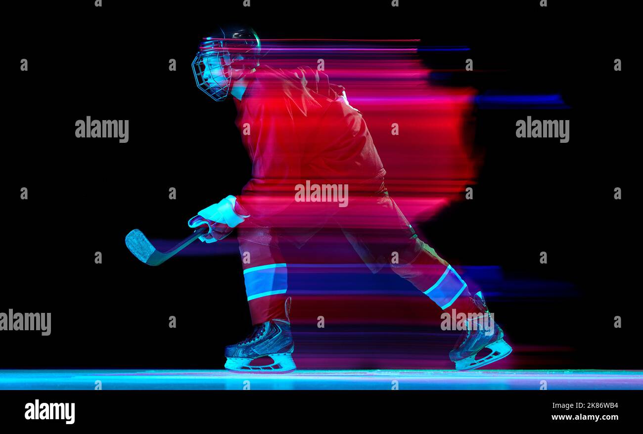 Powerful throw. Male ice hockey player in sports protective uniform in