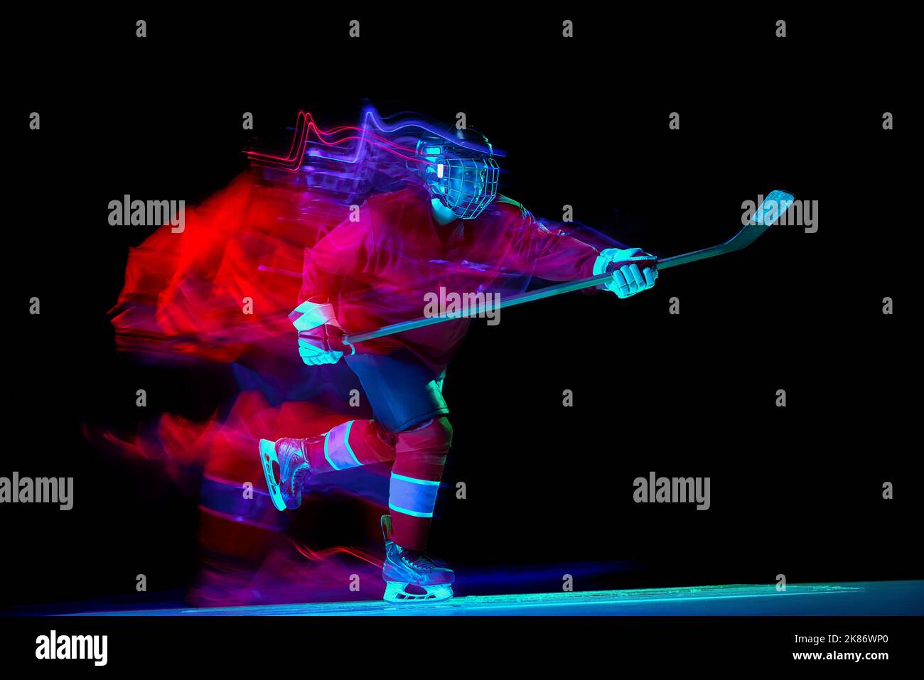 Powerful throw. Male ice hockey player in sports protective uniform in