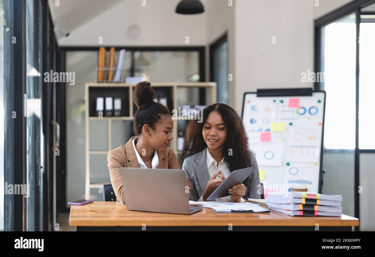 Two young business people working together in office. financial analysis accounting concept. Stock Photo
