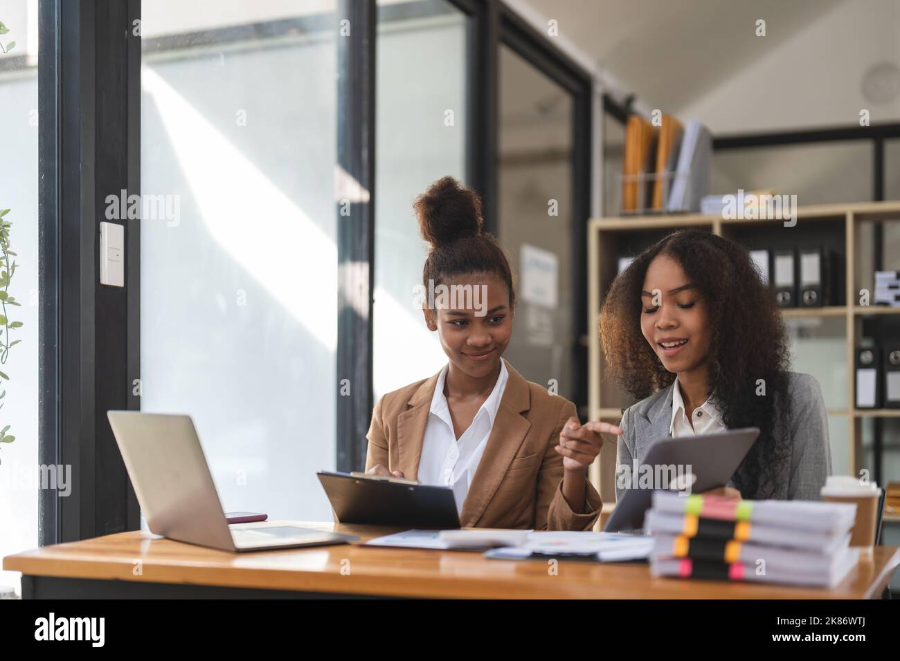 Two young business people working together in office. financial analysis accounting concept. Stock Photo