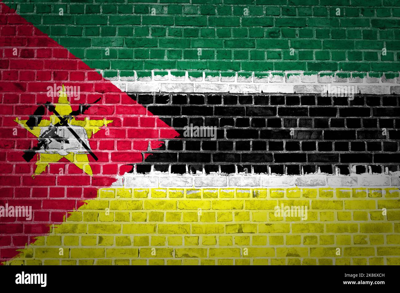 An image of the Mozambique flag painted on a brick wall in an urban location Stock Photo