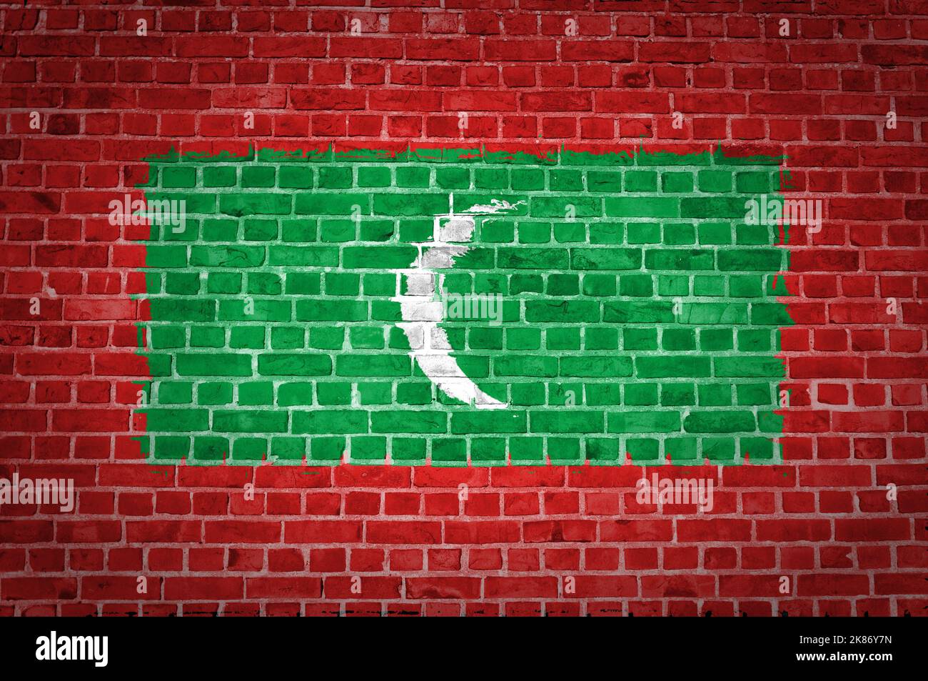 An image of the Maldives flag painted on a brick wall in an urban ...