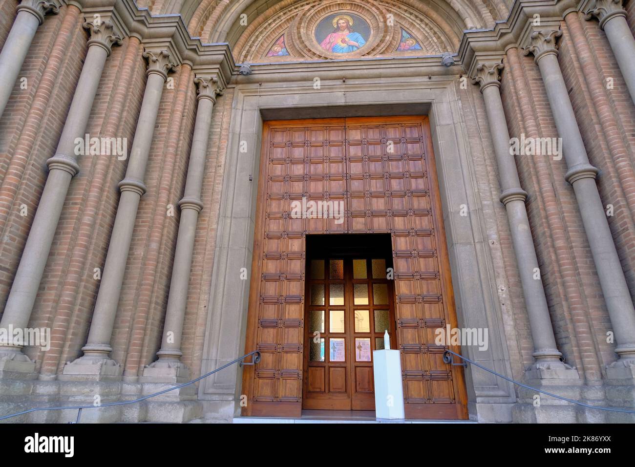 Facade and doors of the Church of the Sacred Heart of Jesus (Parrocchia Sacro Cuore Gesu') in Bologna, Italy. Religious architecture Stock Photo
