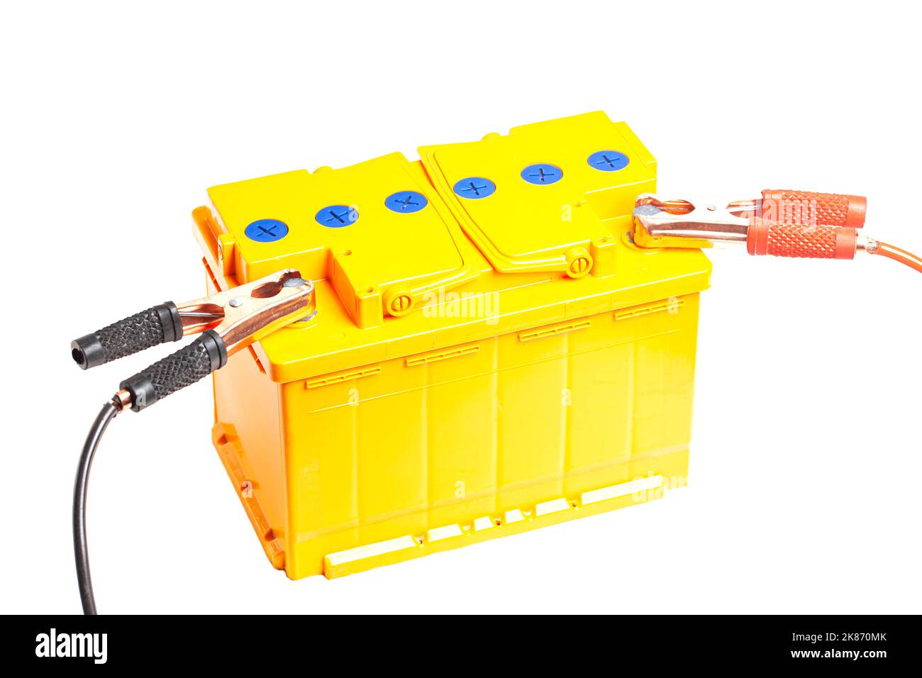 Charging the car acid battery. The charger terminals are connected to the battery. Car acid battery with charger terminals close-up Stock Photo