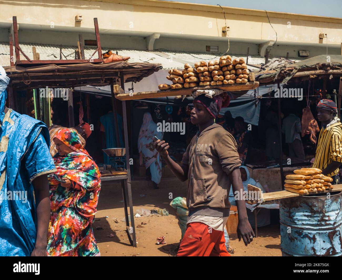 A man carrying bread at the market of a village near Ayoun El Atrous, Hodh El Gharbi, Mauritania, Sahara Desert, West Africa, Africa Stock Photo