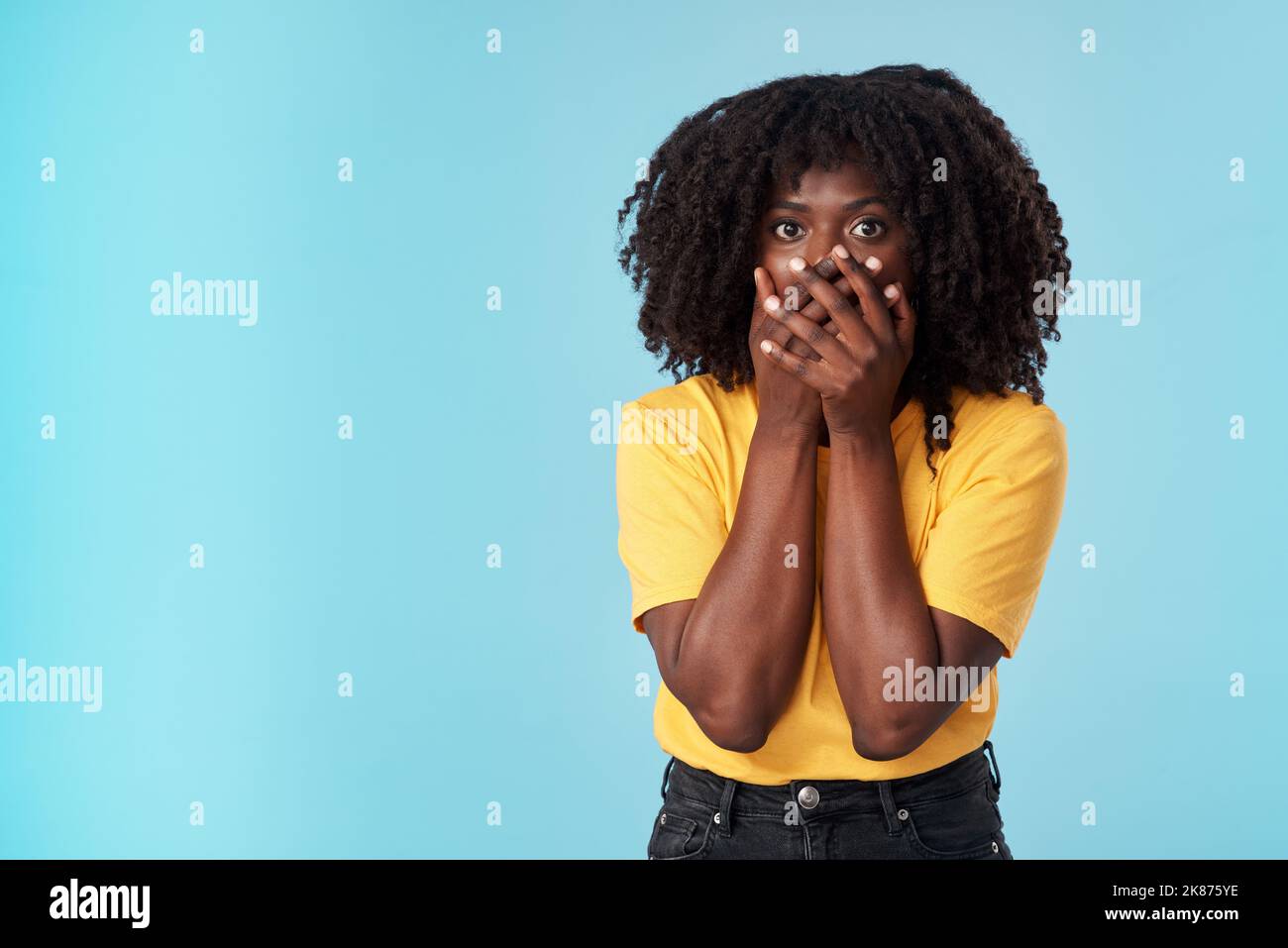 Life just changed in one moment. Studio shot of an attractive young woman looking shocked against a blue background. Stock Photo