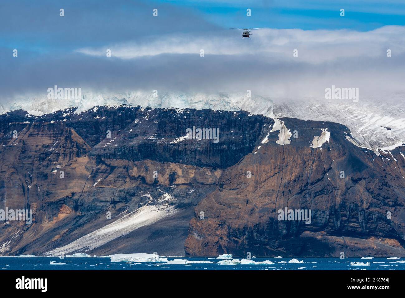 Helicopter in flight over Brown Bluff, Weddell Sea, Antarctica, Polar Regions Stock Photo