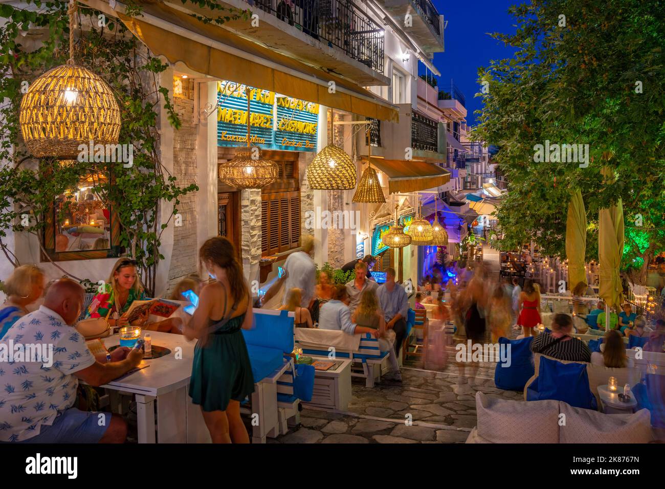 View of restaurant and bars in Skiathos Town at dusk, Skiathos Island, Sporades Islands, Greek Islands, Greece, Europe Stock Photo
