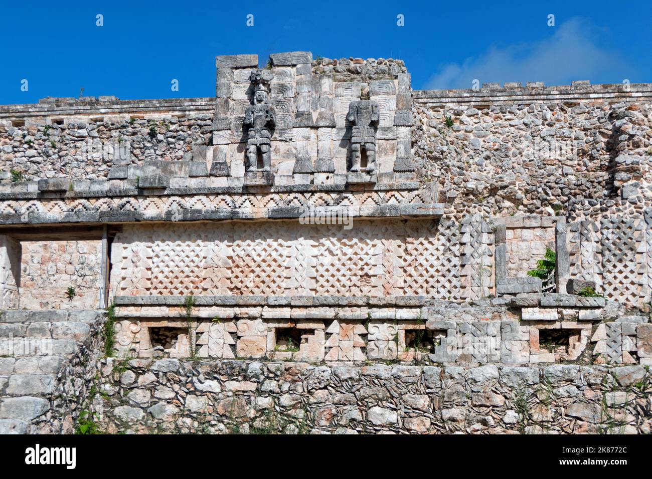 Details and close-up of bas-reliefs, decorations and statues on the Codz Poop palace at the Maya site of Kabah, Yucatan, Mexico. Mayan art on old buil Stock Photo