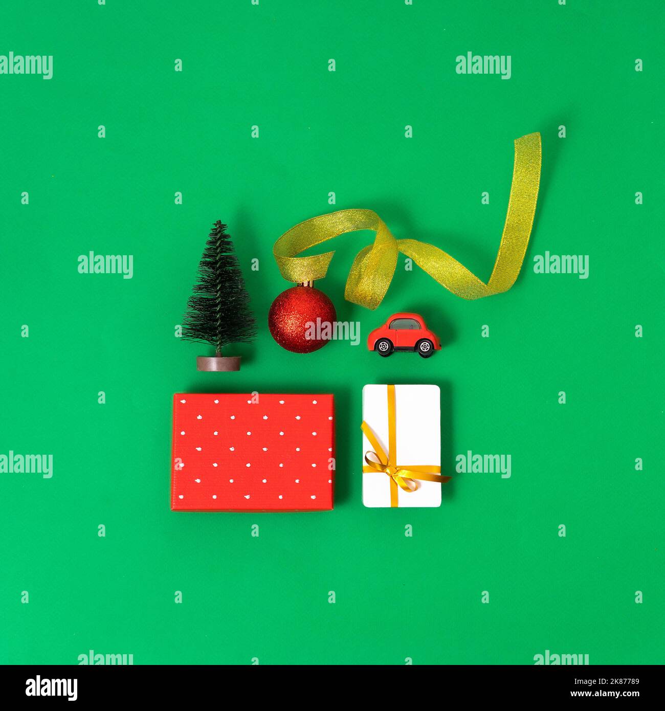 Trendy composition of Christmas objects, a gift box and a bonus, bank card on a green background Concept of christmas sales and shopping Stock Photo