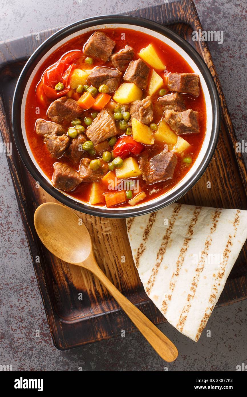 Orman Kebabi Forest Kebab slow cooked meat stew with vegetables closeup in the bowl on the table. Vertical top view from above Stock Photo