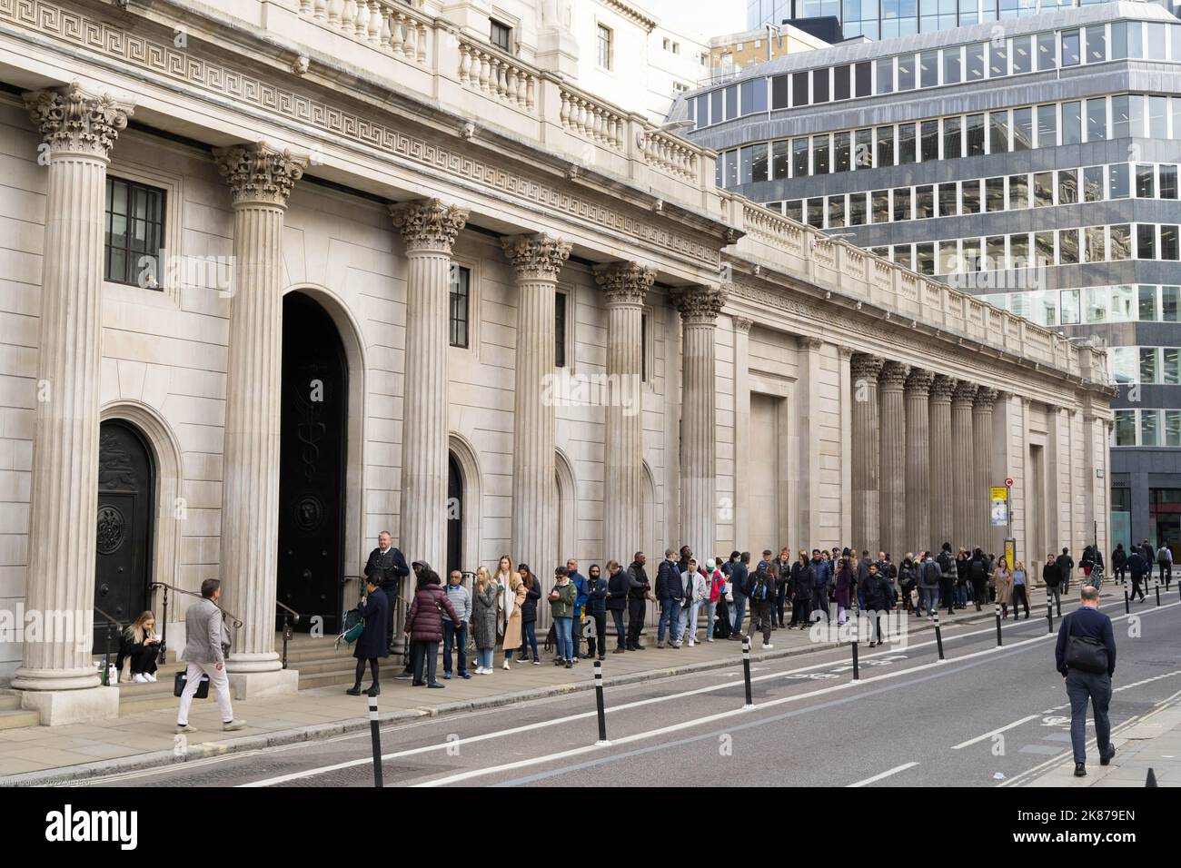 A line of queue formed outside the entrance into the central  Bank of England London England UK Stock Photo