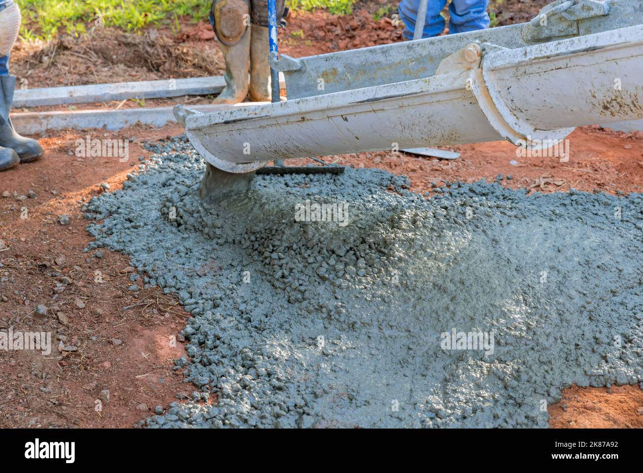 In this concrete construction company pouring wet concrete while paving