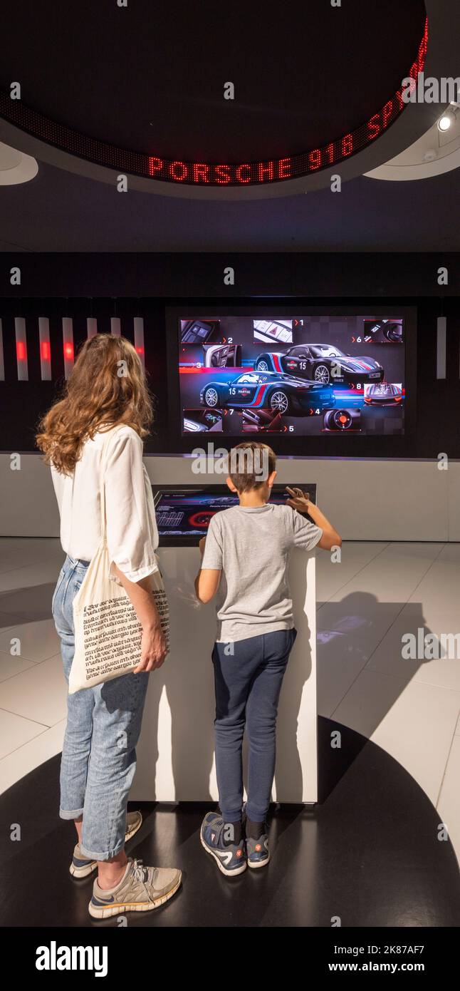 mother and son at interactive computer display, The Porsche Museum, Stuttgart, Germany Stock Photo
