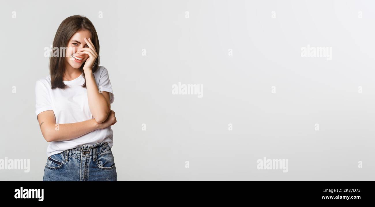 Flirty and silly girl blushing and smiling coquettish Stock