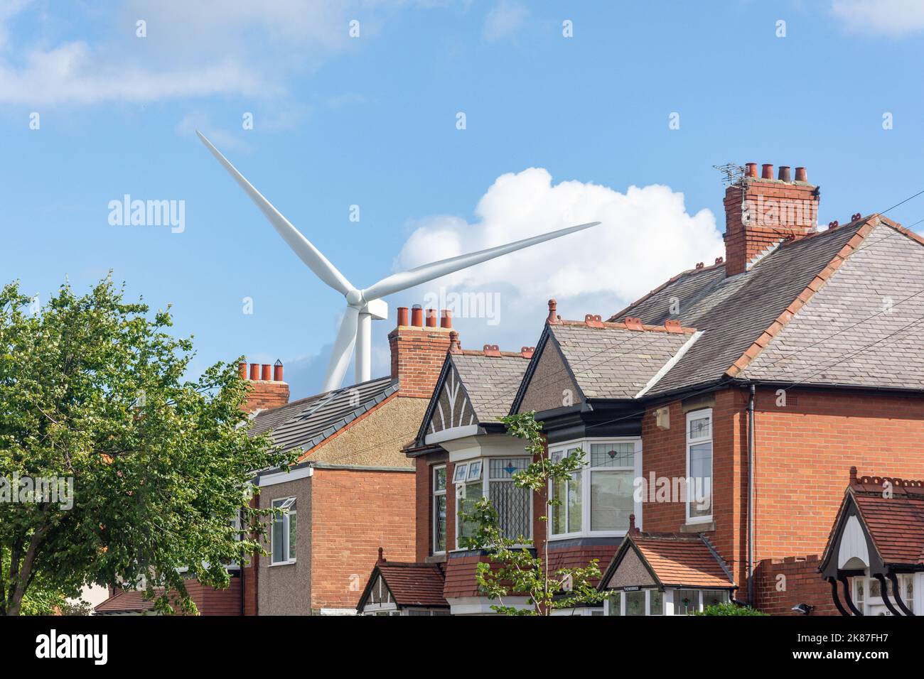 Street scene with wind turbine behind, Blyth, Northumberland, England, United Kingdom Stock Photo