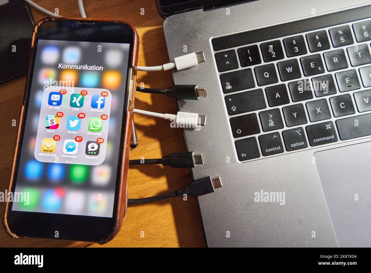 Screen of an iphone 13 plus with many notifications of received social media messages and the new standard EU USB-C cable from 2024 on Oct. 21, 2022 in Marktoberdorf, Germany.  EU agreement on USB-C Unified charging socket for smartphones, laptops and digital cameras, tablets, cameras, headphones and portable speakers, single charging cable, unified charging ports for electronic devices. © Peter Schatz / Alamy Live News Stock Photo