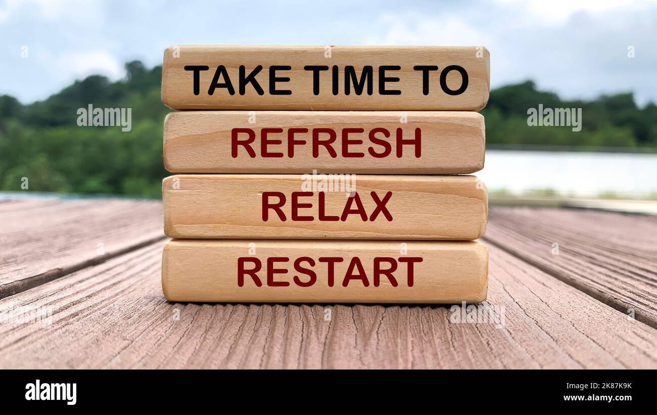 Take time to refresh, relax and restart text on wooden blocks with nature and park background. Stock Photo