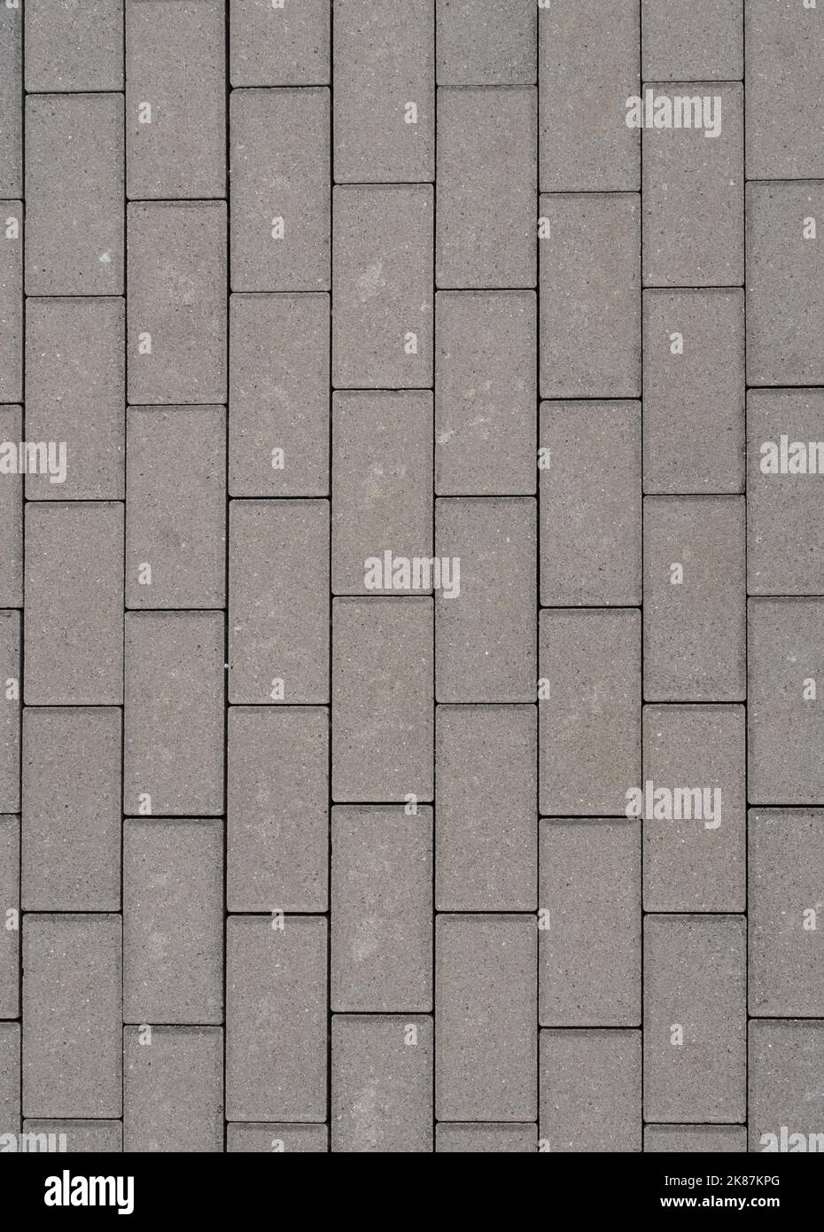 Grey concrete pavement with with rectangular plates for background. Front view with copy space. Stock Photo