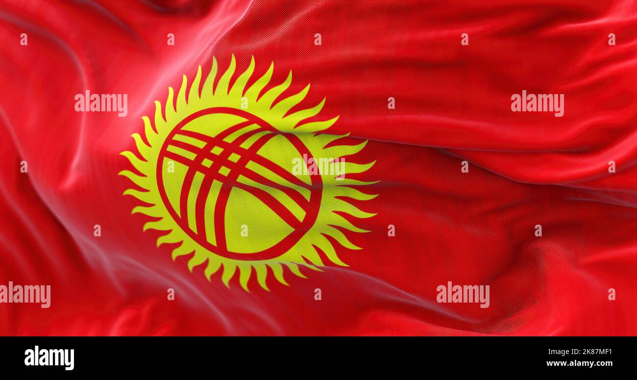 Close-up view of the Kyrgystan national flag waving in the wind. The Kyrgyz Republic is an independent State of Central Asia. Fabric textured backgrou Stock Photo