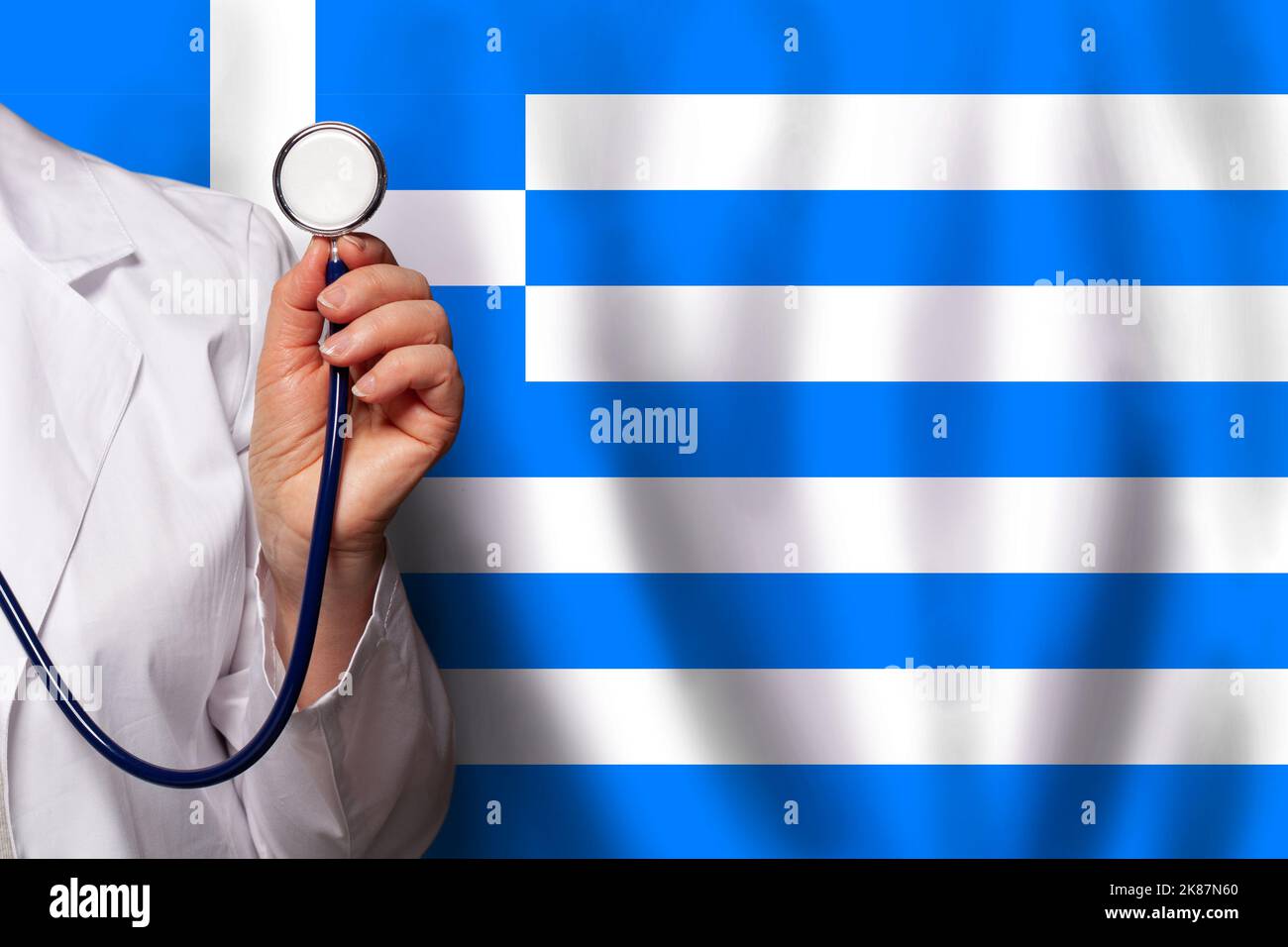 Greek medical worker's hand with stethoscope on flag of Greece background Stock Photo Alamy