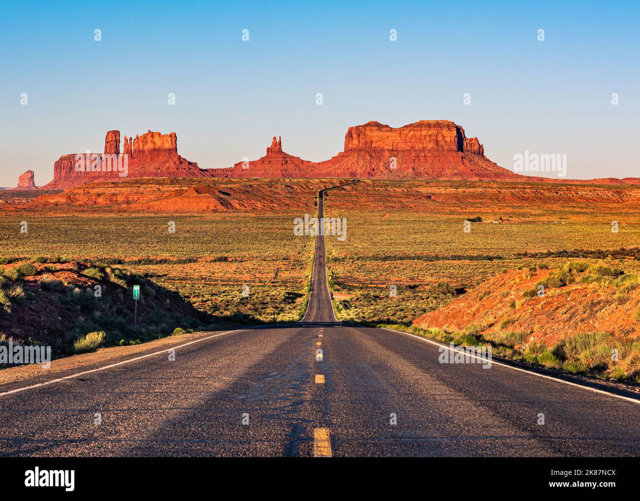Classic sunrise view of Monument Valley and highway 163 at milepost 13. Stock Photo