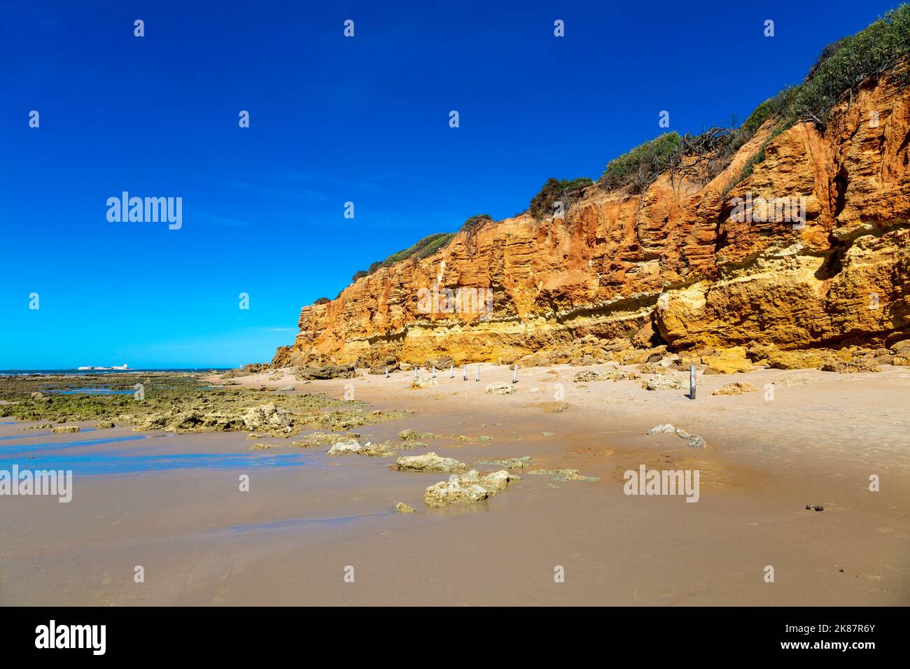 Orange rocks along Playa Sancti Petri, Costa de la Luz, Cadiz, Spain Stock Photo