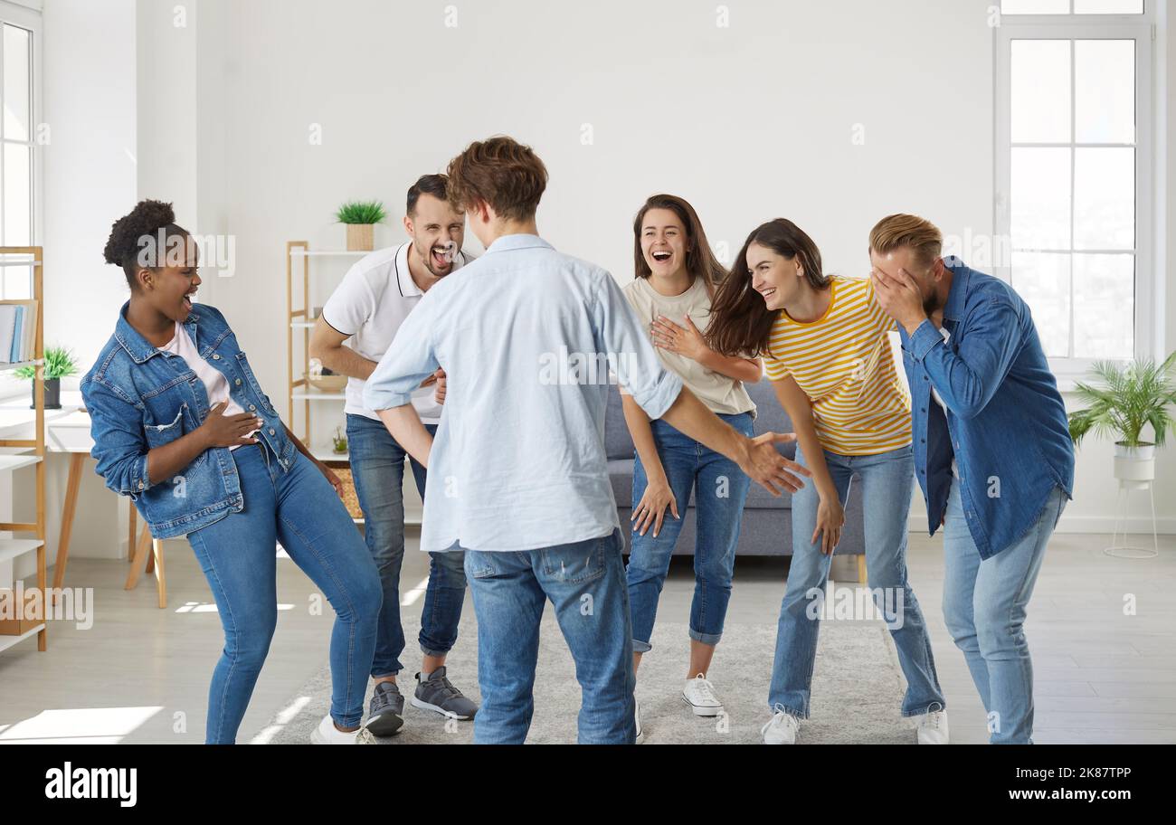 Group of happy young multiracial friends laughing at a very funny joke all together Stock Photo