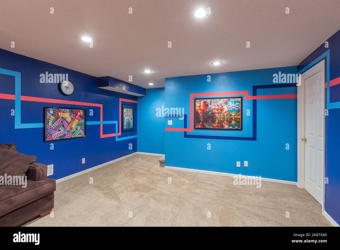 A modern living room interior with paintings on blue walls in Kansas