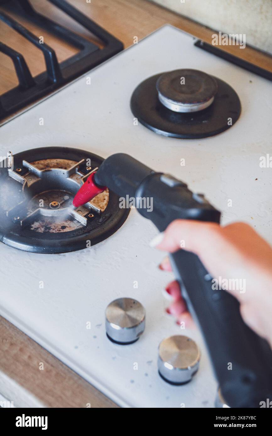 Glass ceramic stove cleaning with a steam cleaner, house disinfe Stock