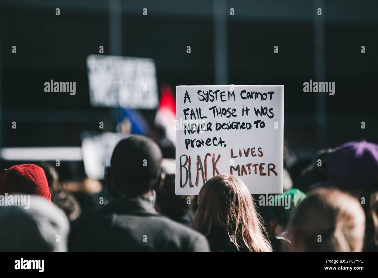 A sign saying black lives matter surrounded by a crowd in Alberta Stock Photo