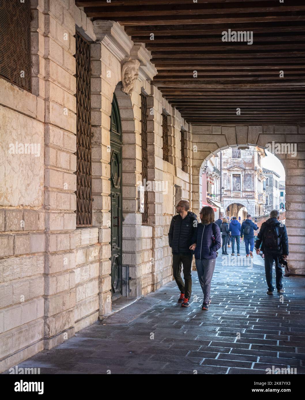 Street in the historic town of Chioggia, Venetian lagoon, Veneto region, northern Italy - people walking Stock Photo