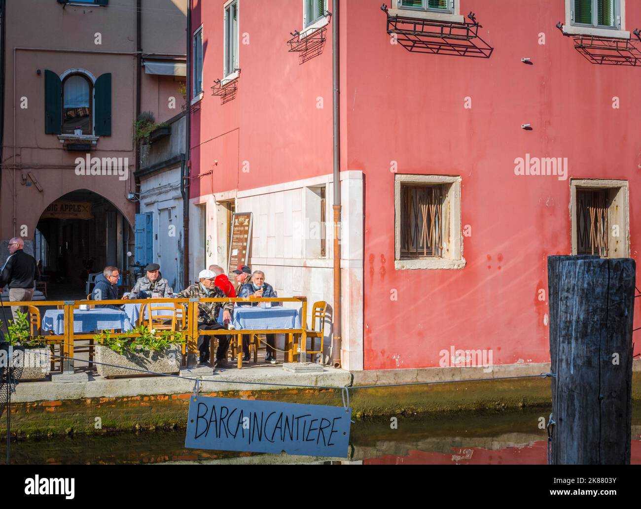 Tourists at the outdoor tables of restaurant Chioggia along the canal - Chioggia, Venetian lagoon, Veneto region,northern Italy - october 30 - 2021 Stock Photo