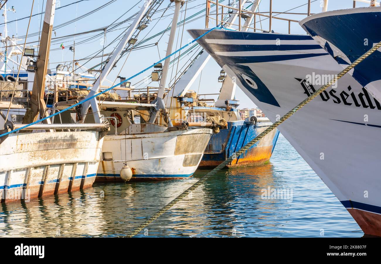 Fishing trawlers of Chioggia city, Venetian Lagoon, Verona province, northern Italy - boats docked along the canal Stock Photo
