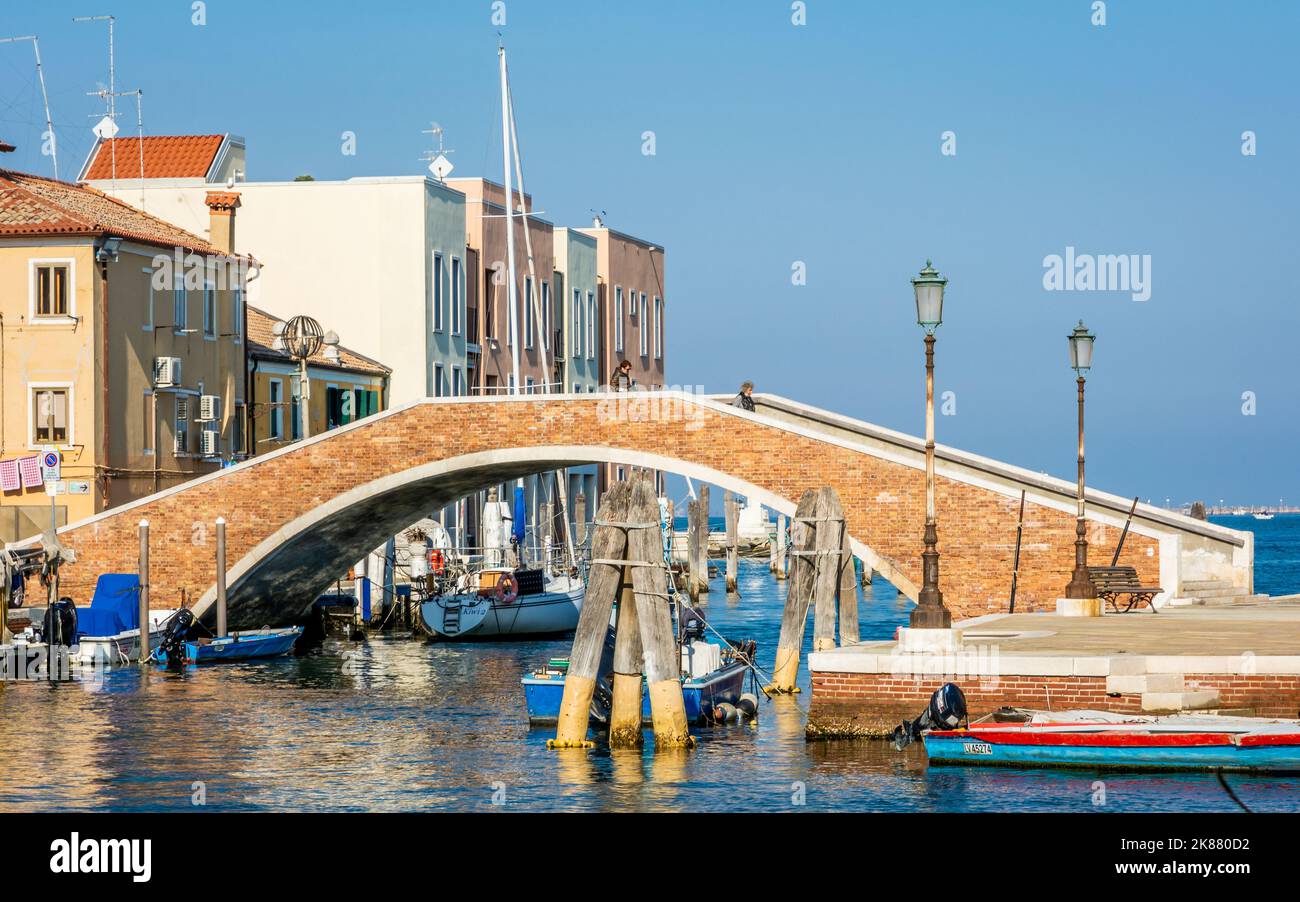 Chioggia cityscape with narrow water canal Vena with moored multi colored boats - Venetian lagoon, Veneto region, northern Italy Stock Photo