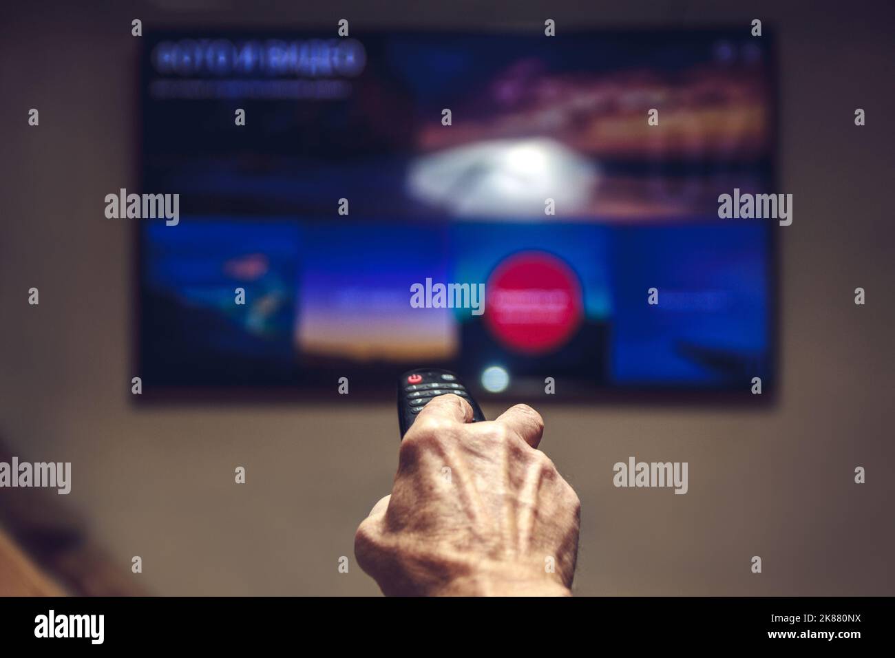 elderly man hand holding TV remote control Stock Photo Alamy